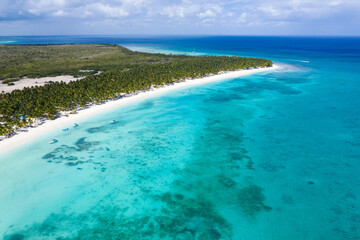 Saona island with coconut palm trees and turquoise caribbean sea. Dominican Republic. Aerial view