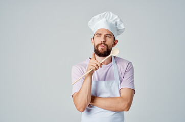 chef with wooden spoon in hand working kitchen professional