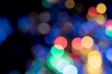 Fototapeta premium Colored blurred bokeh balls with depth and glow on black background for overlay