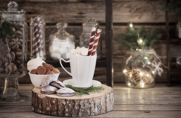 Christmas decoration cocoa bar with cookies and sweets on old wooden background in  natural rustic style. Winter cozy concept