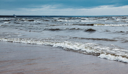 Atmospheric scenery Dramatic Baltic sea, waves and water splashes on breakwaters