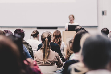 Woman giving presentation on business conference event
