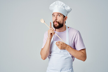 Naklejka premium a chef with a wooden spoon in the hands of a professional restaurant service