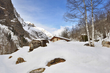 alpine mountain in the snow with  a chalet burried in snow