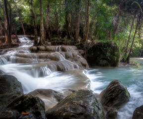 Erawan Waterfall at Kanchanaburi in Thailand during rainy season. Water flowing down through the layers of limestone.