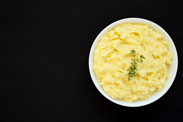 Homemade Garlic Mashed Potatoes on a black background, top view. Flat lay, overhead, from above. Copy space.