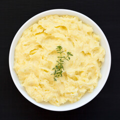Homemade Garlic Mashed Potatoes on a black background, top view. Flat lay, overhead, from above.