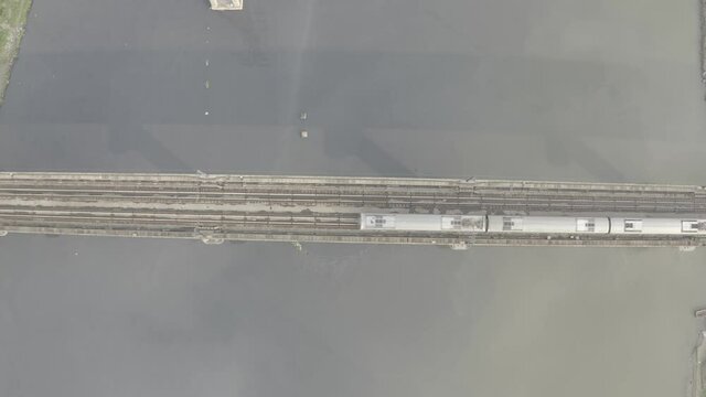 An aerial shot of the Delhi Metro running over the Loha Pull during Covid-19 Lockdown at New Delhi,India
