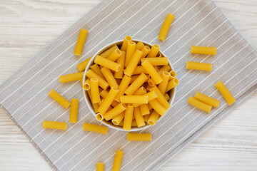 Dry Rigatoni Pasta in a gray Bowl, top view. Flat lay, overhead, from above.