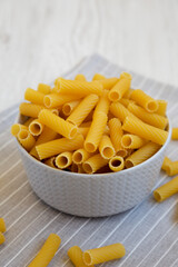Dry Rigatoni Pasta in a gray Bowl, low angle view.