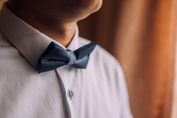 blue butterfly on the groom's suit