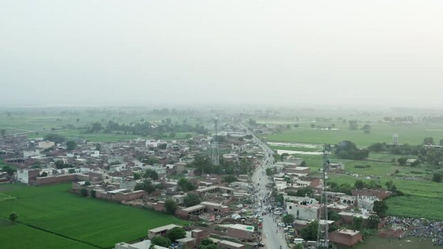 Aerial view of a village in Pakistan. rural landscape with houses and streets near agricultural fields.