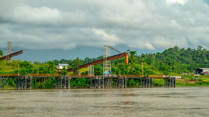 Fototapeta na wymiar Huge conveyor at Mahakam Riverbank used to load coal to the barge. Industrial and mining background