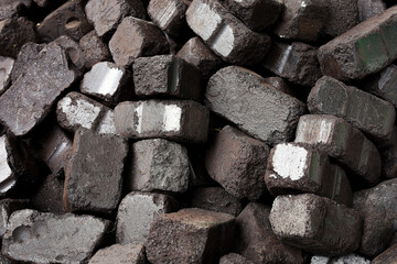 Closeup view of black charcoal, coal briquets. Coal texture background. Energy resource, heating, industrial use.