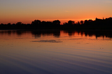 Obraz premium Sunset on the river in summer