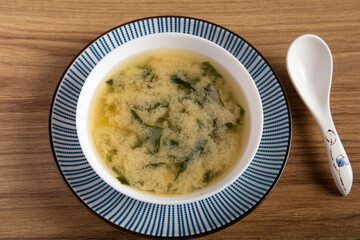 bowl of miso soup on a wooden background. Traditional oriental cuisine