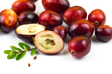 Cranberries isolated on white with green leaf, half with seeds and whole fresh red fall berry