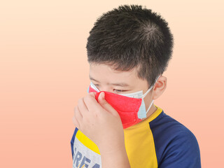 Boy wearing a double layer mask to prevent covid 19 virus on isolated background. The concept of wearing a double mask self defense