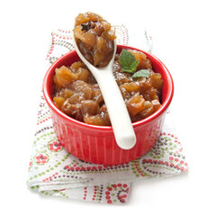 Homemade chutney, apple jam in a red bowl on the white background