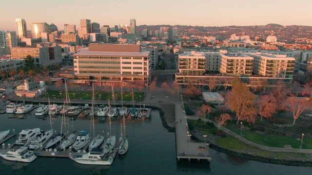Aerial: Jack London Square and downtown Oakland at sunset, California, USA