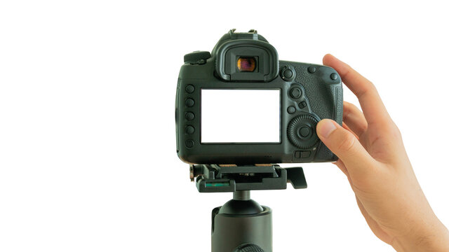 Hand taking pictures blank screen on isolated white background, Camera on a tripod, Photographer hands holding professional DSLR camera, Mockup image.