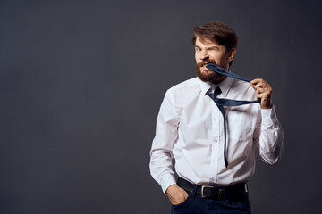 bearded man in a white shirt pulls the tie isolated background