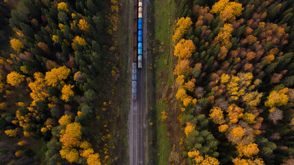 Aerial view of railway tracks and train in autumn. © Сергей Теребов