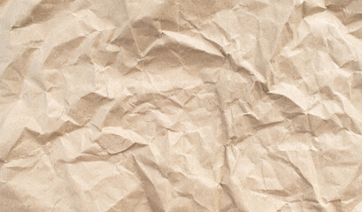 Recycled brown creased paper background from a paper packing. Crumpled brown paper texture concept
