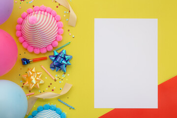 Happy birthday background, Flat lay colorful party decoration with flyer invitation card on pastel yellow background.