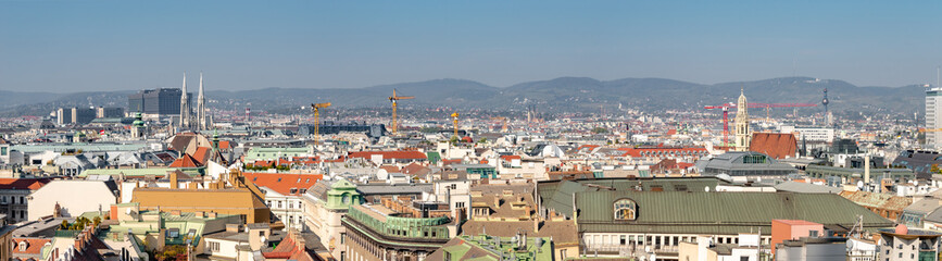 Panoramic bird view over warm sunset in in historical touristic downtown with many old and modern buildings, Vienna, Austria.