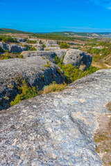 Ancient stone caves in a town-fortess Eski-Kermen high in a rocky mountains, Crimea.