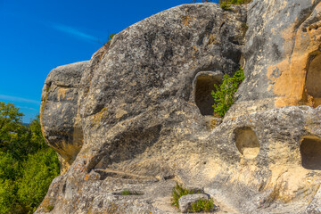 Ancient stone caves in a town-fortess Eski-Kermen high in a rocky mountains, Crimea.