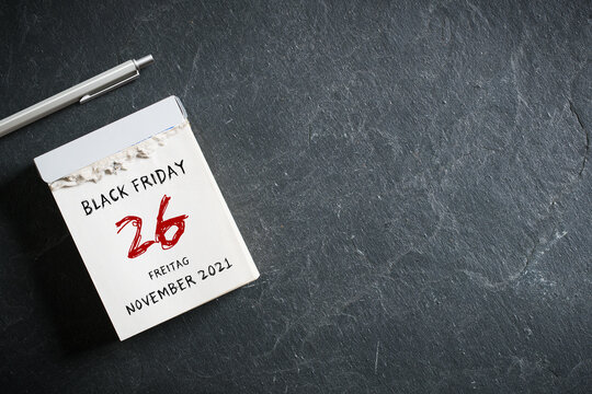 tear-off calendar with German message for BLACK FRIDAY 26th NOVEMBER 2021 on slate background