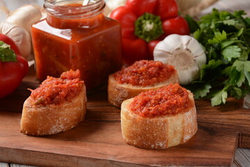Ajvar, a delicious roasted red pepper and eggplant dish. Traditional macedonian serbian dish made from red bell peppers, eggplant and garlic, lutenitza, popular in Balkans