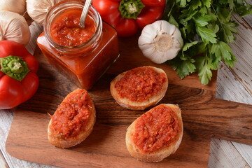 Ajvar, a delicious roasted red pepper and eggplant dish. Traditional macedonian serbian dish made from red bell peppers, eggplant and garlic, lutenitza, popular in Balkans