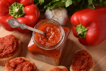 Ajvar, a delicious roasted red pepper and eggplant dish. Traditional macedonian serbian dish made from red bell peppers, eggplant and garlic, lutenitza, popular in Balkans
