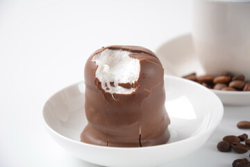 White Chocolate Krembo on the table. A chocolate-coated marshmallow treat that is popular in Israel.