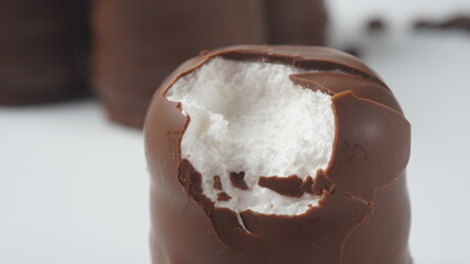 White Chocolate Krembo on the table. A chocolate-coated marshmallow treat that is popular in Israel.