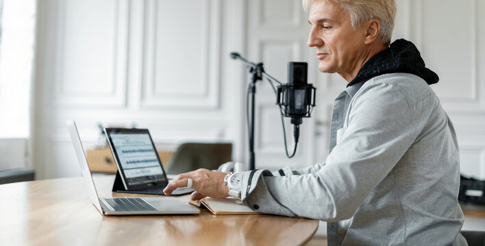 A freelancer puts on music for listeners. This person works in a radio studio. The radio host transmits the news and speaks into the microphone. A man's favorite job.