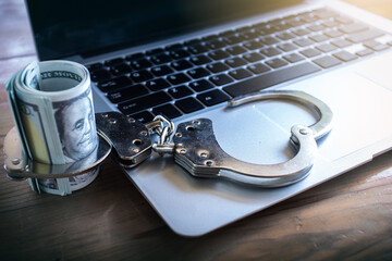 Financial risk, debt default concept : US USD dollar, laptop, silver handcuff.