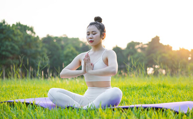 image of asian woman doing yoga outdoors