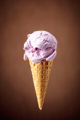 Blueberry ice cream in waffle cone.