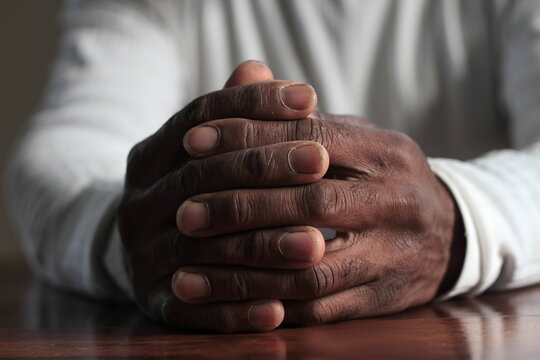 man praying with hand on bible white background stock photo