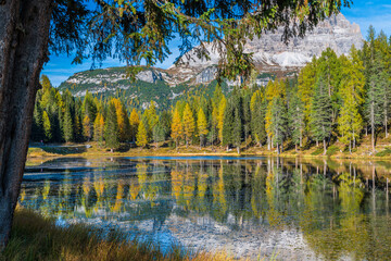Fototapeta premium Autumn colors on the lake of Antorno. Magical glimpses of the Dolomites. Three peaks of Lavaredo