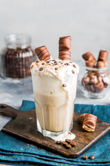 Latte with chocolate on a wooden board