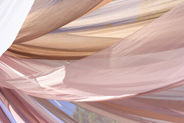 Pink thin fabric is hung against the sky on a sunny day. High quality photo