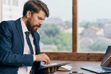 entrepreneur near the window with a laptop office