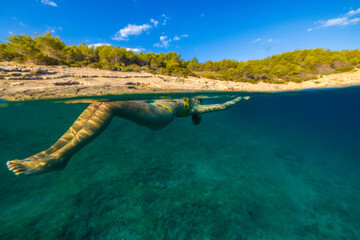 Girl diving in the Adriatic Sea on Hvar island, Croatia