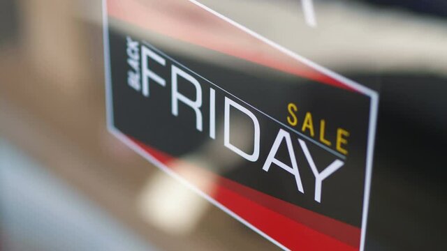 Black Friday Sale sign hanging on the door in 4K Slow motion 60fps