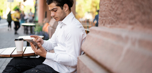 A banker counts finances online. The lawyer responds to clients by email.  The manager is working on a laptop near the office on the street.